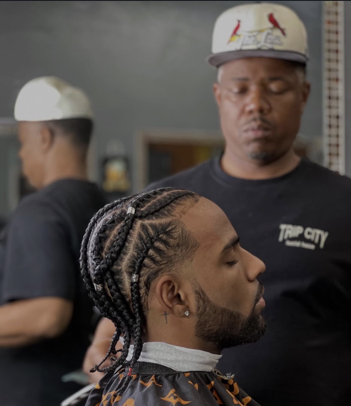 Braids with a clean line-up and beard shape up