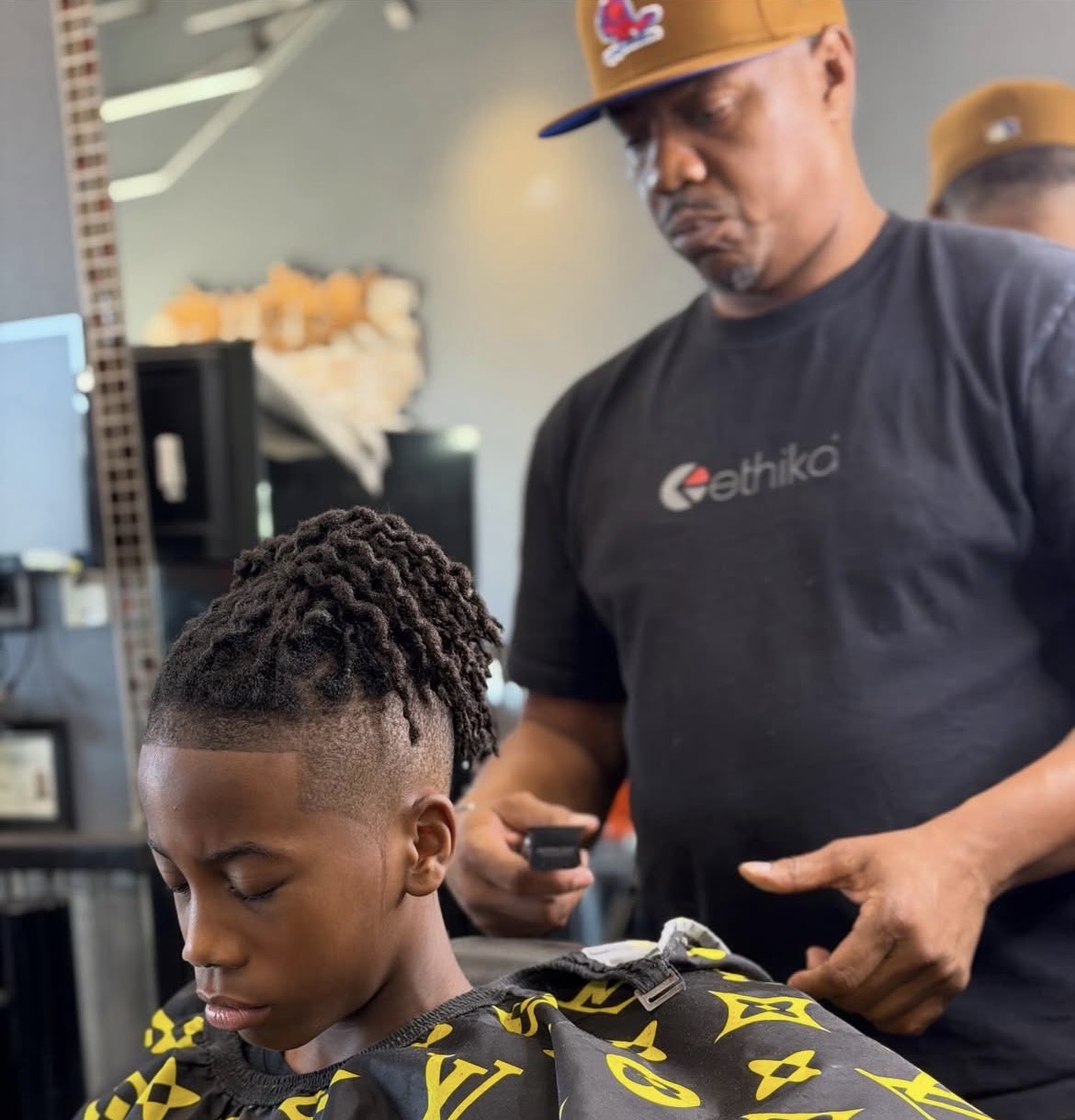 Kids high-top locs cut with a clean fade