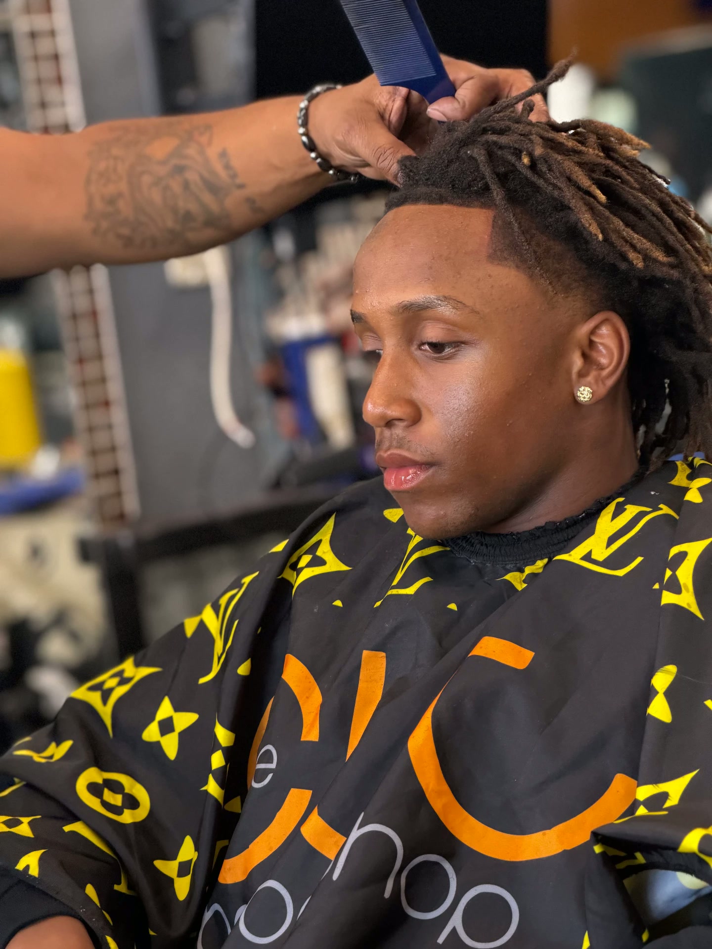 Locs styled with a fresh fade in the chair
