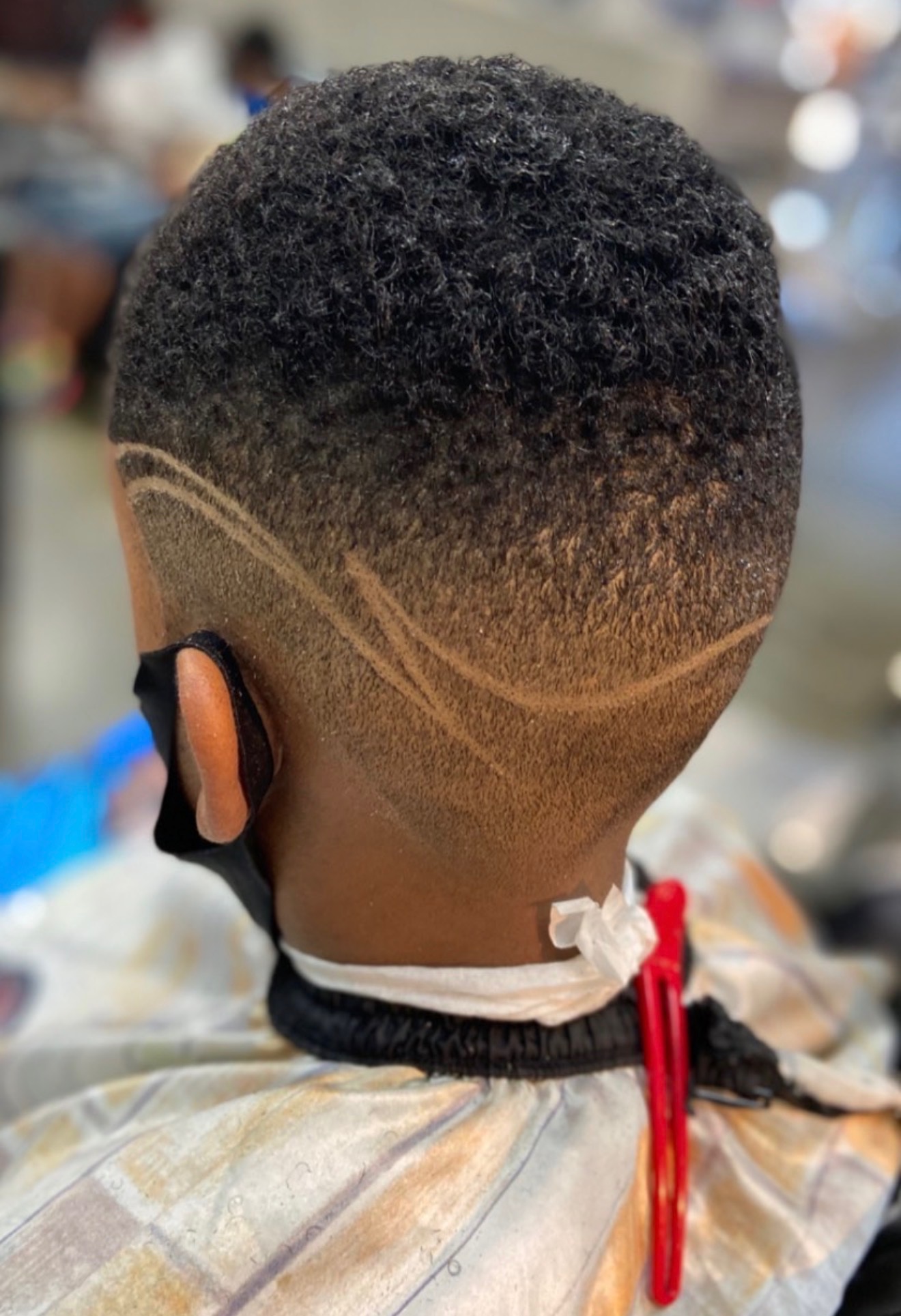 Custom hair design carved into a fresh fade