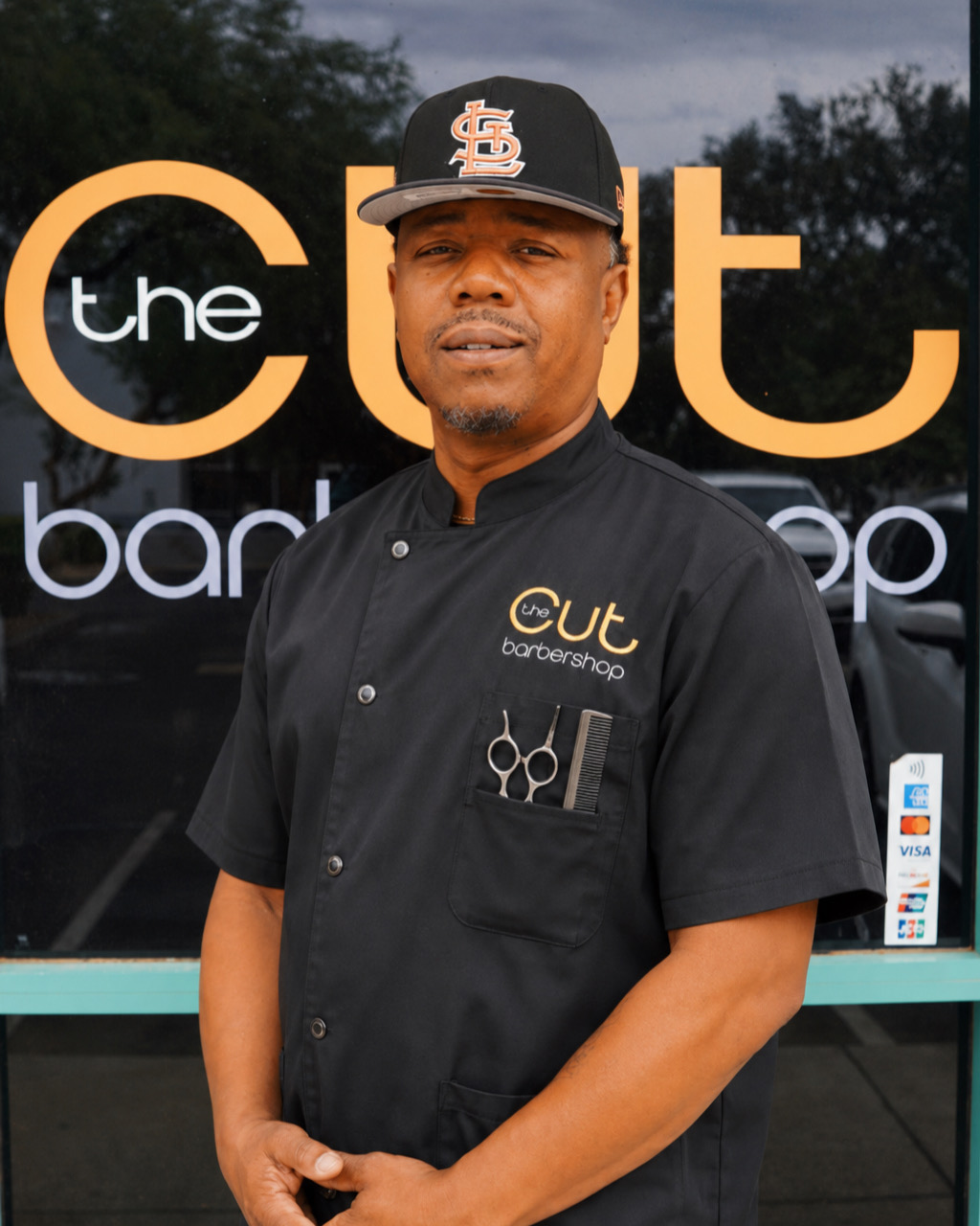 KD — professional barber standing outside the shop